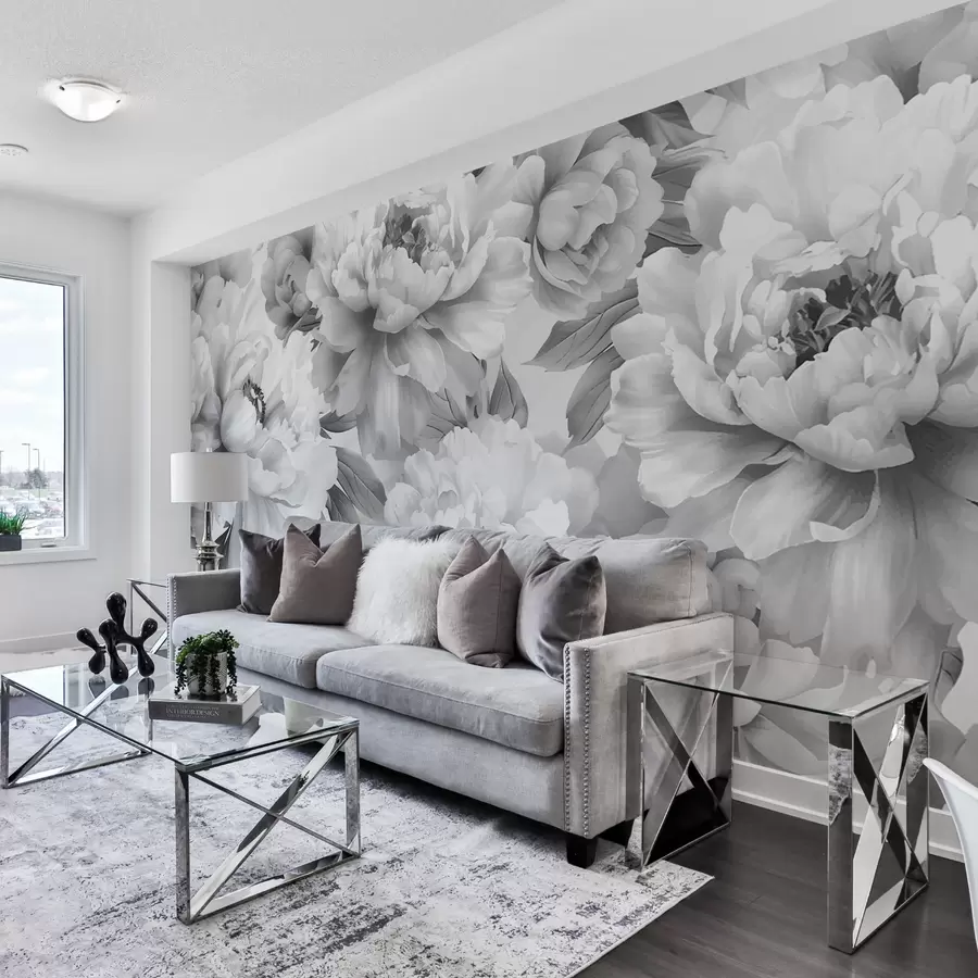 A grey and white living room with sofa and cushion on it