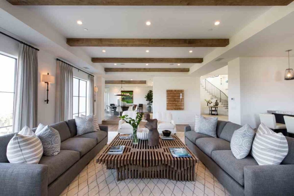 A white and grey living room with brown accents