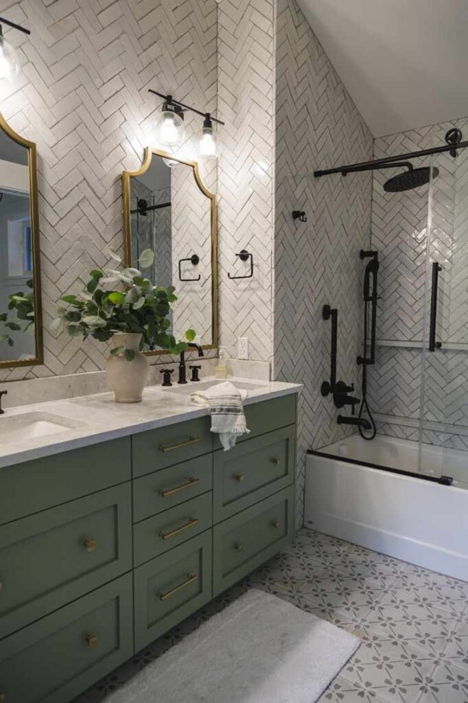 A grey bathroom wit sage green vanity and black fixture 