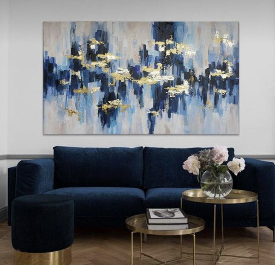 A grey living room with blue sofa and table and wooden floor 