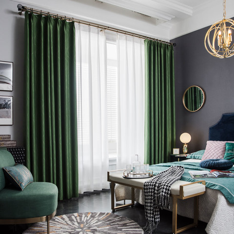 A black bedroom with satin curtain and mirror on the wall 
