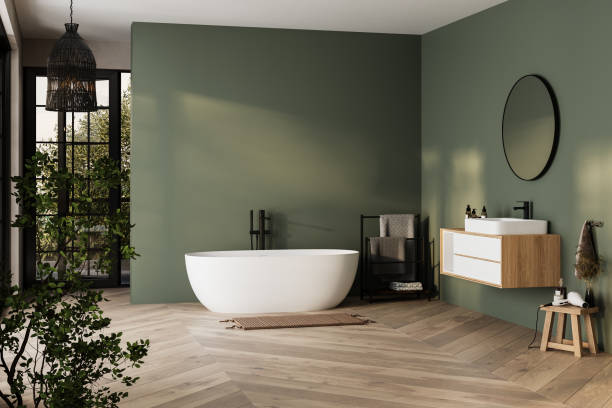 A green and black bathroom with white bathtub and wooden floor and mirror on the wall 
