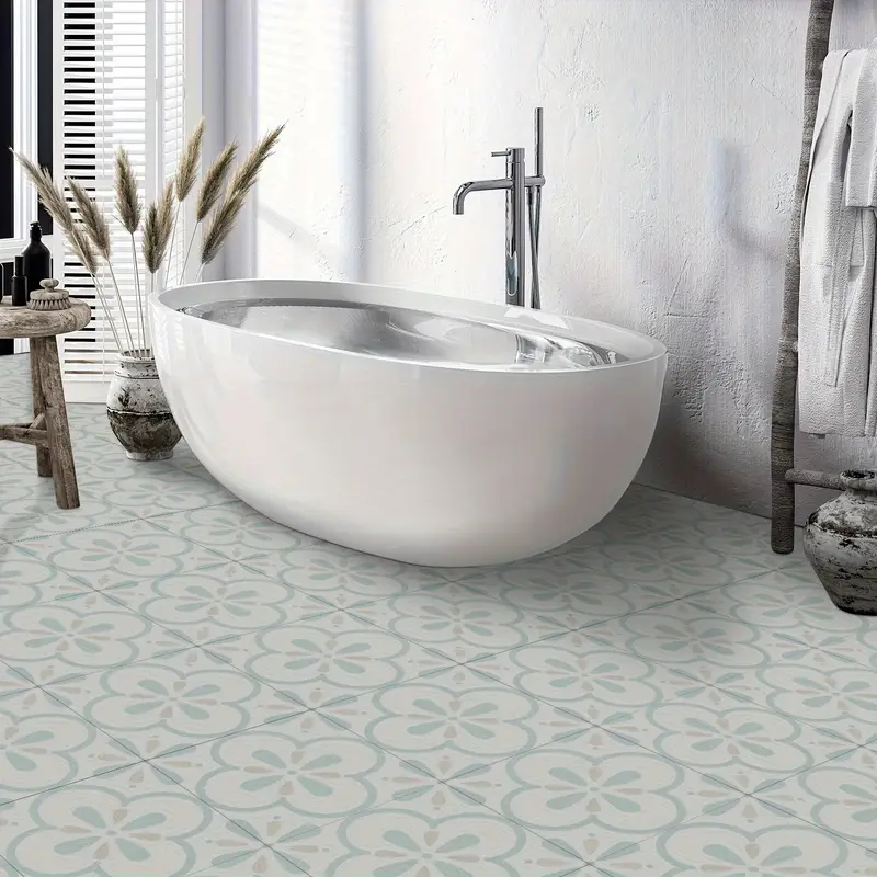 A bathroom with morcart Art-deco peel and stick floor tile and white bathtub 