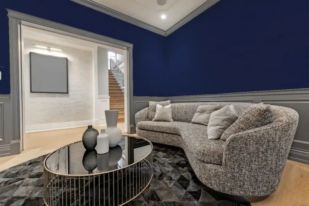 A blue living room with grey sofa and wooden floor 