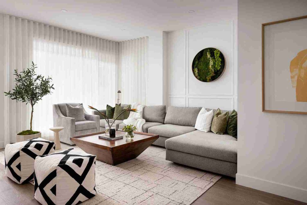 A white living room with grey sofa and cushion and wooden table and rug on the wooden floor