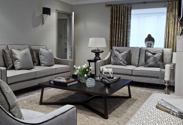 A grey living room with chair and black table and 