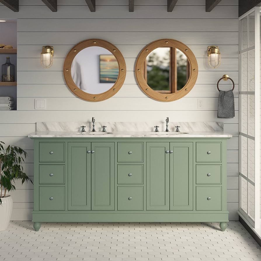 A sage green cabinet and mirror on the wall and light