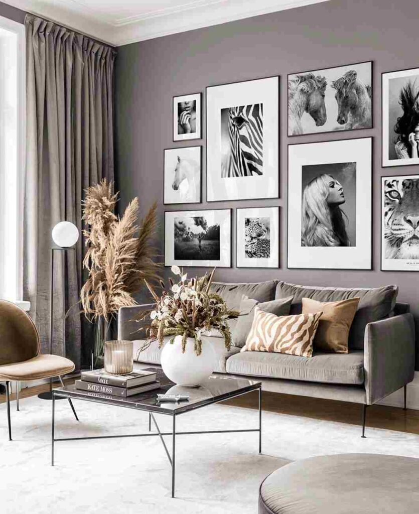 A grey living room with white frames on the wall and sofa with cushion