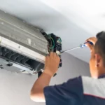 a person fixing ac