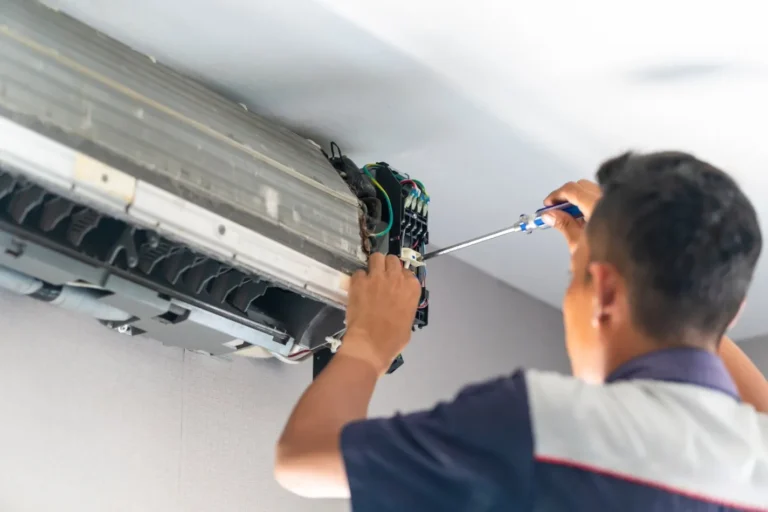 a person fixing ac