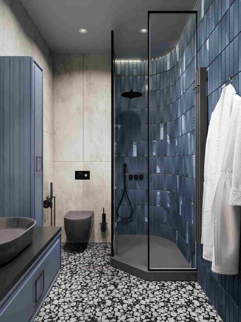 A blue and grey bathroom with black fixture and glass shower door 