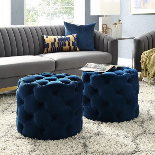 A grey living room with blue ottoman and grey sofa 