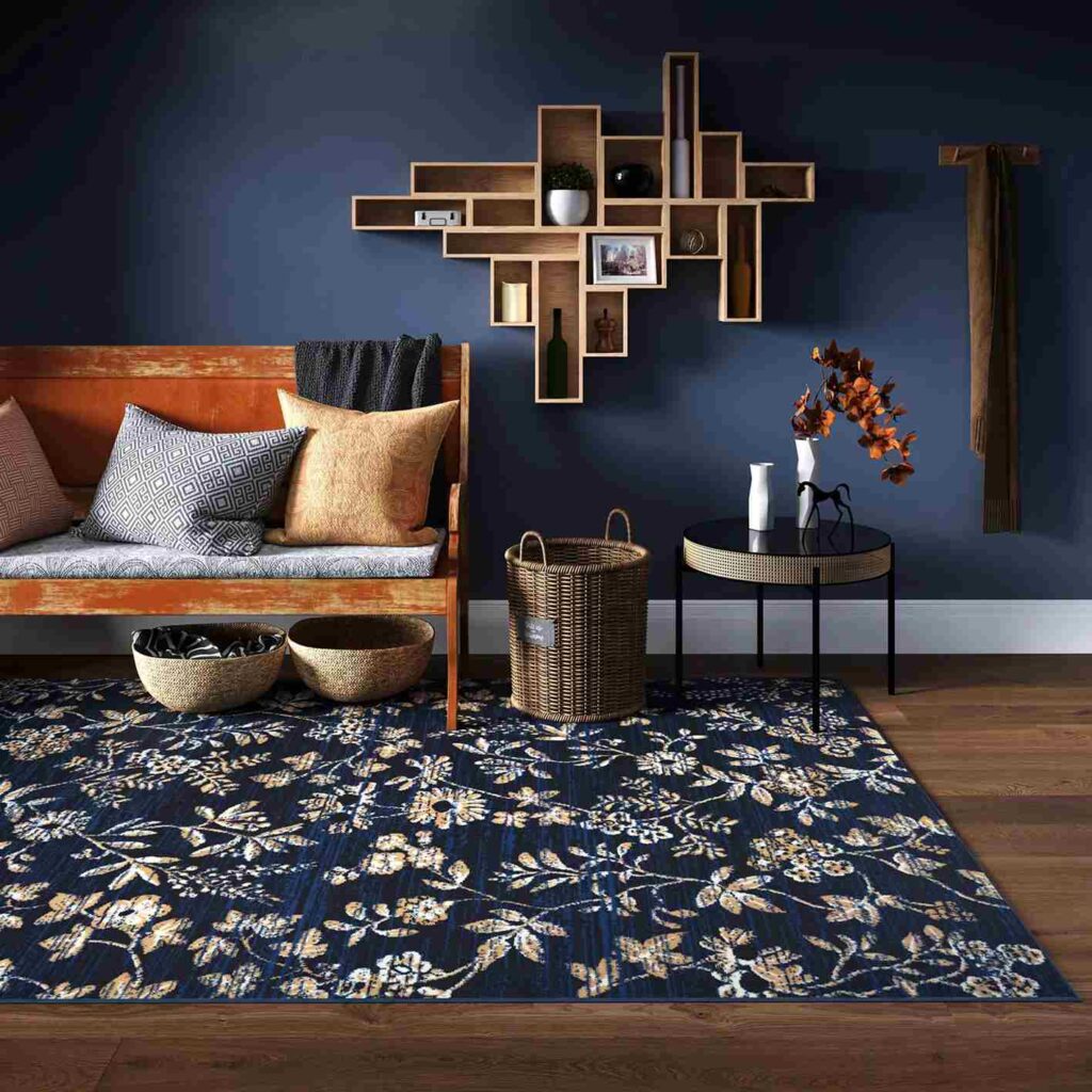 A navy blue living room with sofa with cushion and wooden floor and rug on the floor 