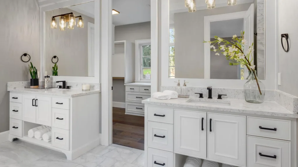 A bathroom with two vanity and light fixture above the wall 