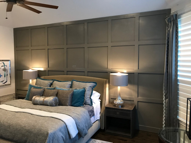 A board and batten wall in bedroom with lamp on the nightstand 