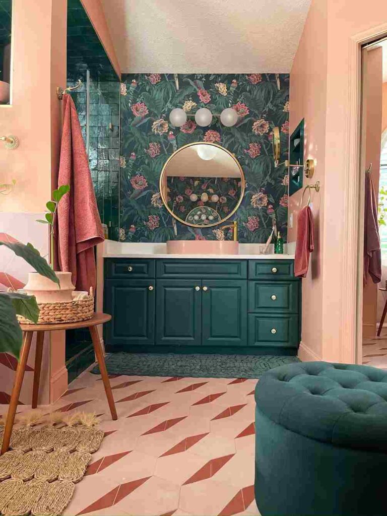 A green wallpaper in pink bathroom with mirror on the wall and green vanity
