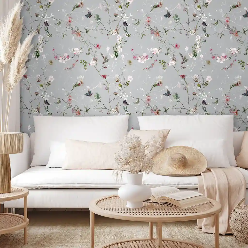 A grey living room with floral wallpaper and sofa with cushion 