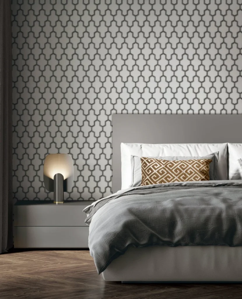 A grey and white bedroom with wallpaper and wooden floor