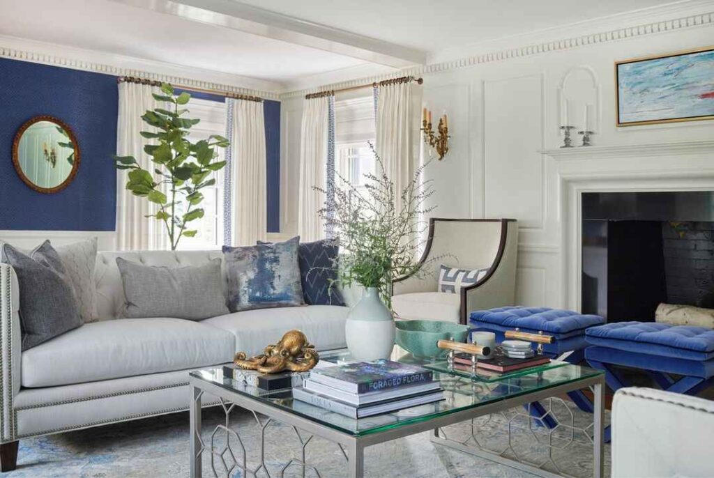 A white and blue living room with grey sofa with cushion and wooden floor
