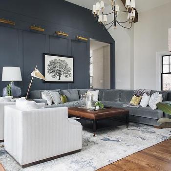 A grey and white living room with sofa and table and rug on the floor