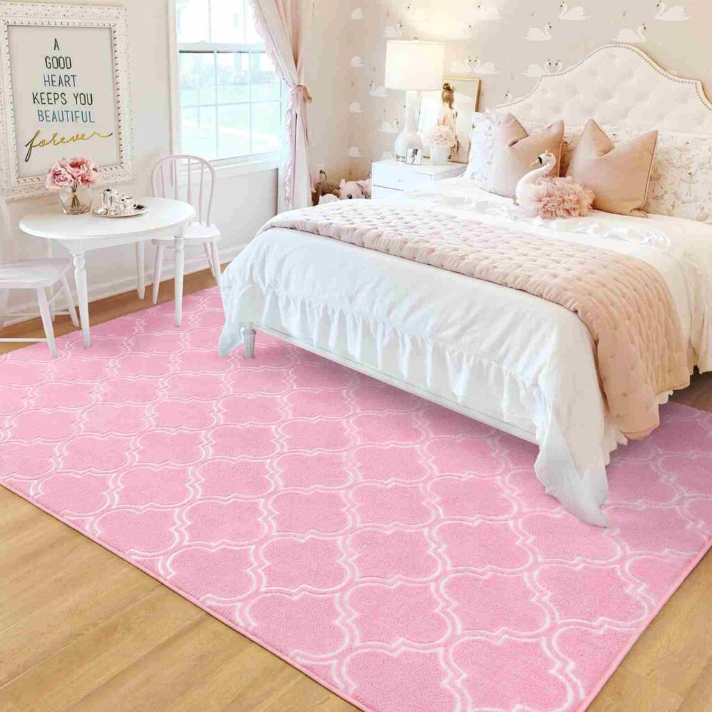 A pink rug on wooden floor in white bedroom with windows and curtain