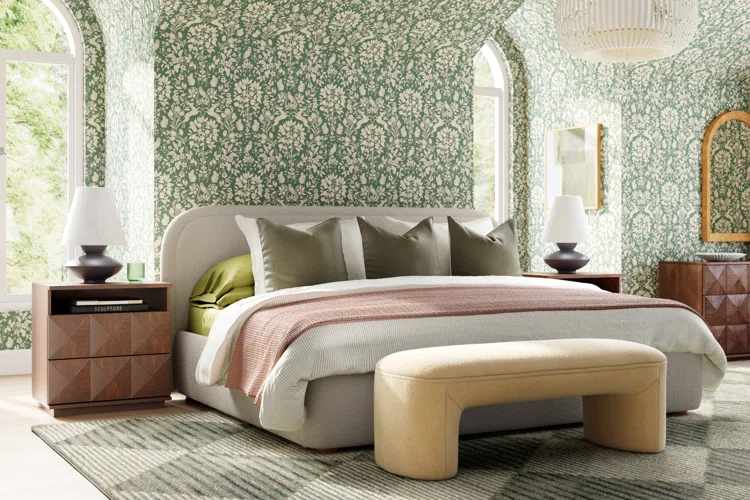 A sage green bedroom with cream textured wall and bed with pillow and blanket 