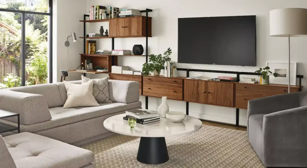 A small living room with tv on the wall and storage 
