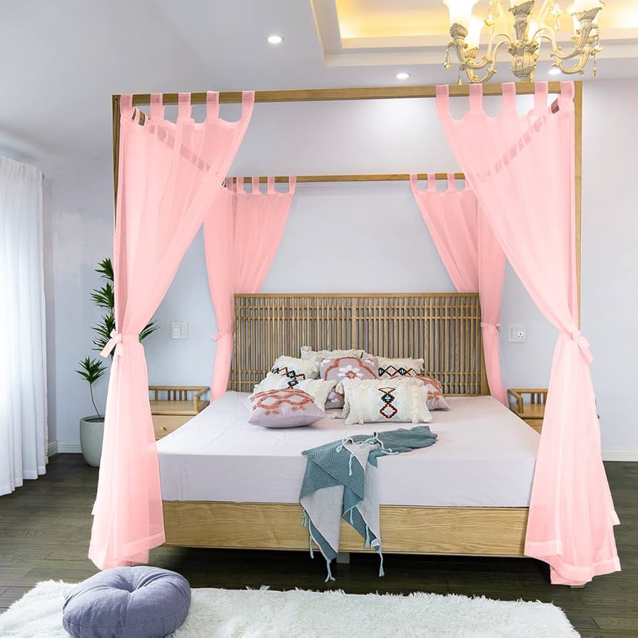 A wooden bed with pink curtains in white bedroom 