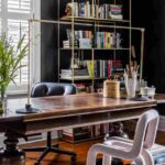 a-home-office-with-a-large-dark-wooden-desk-black-chair-tucked-under-the-desk