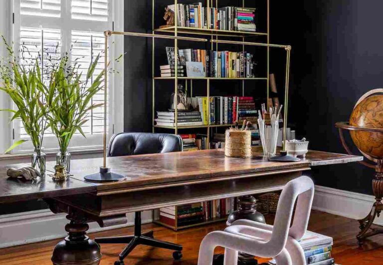 Elevating Your Home Office with Artistic Decor Elements a-home-office-with-a-large-dark-wooden-desk-black-chair-tucked-under-the-desk
