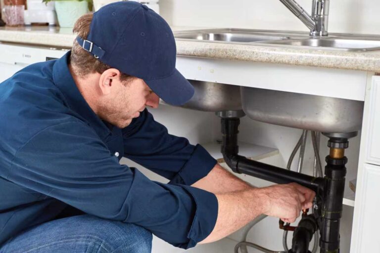 How Regular Drain Maintenance Saves Las Vegas Homeowners Money plumber-is-doing-plumbing-in-kitchen-sink