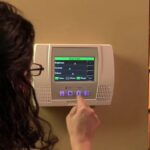 a-digital-alarm-is-hanged-on-a-wall-and-girl-is-clicking-a-button-of-digital-alarm