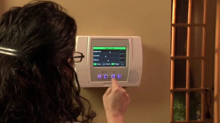 The Ultimate Guide to Honeywell Alarm Codes Every Homeowner Should Know a-digital-alarm-is-hanged-on-a-wall-and-girl-is-clicking-a-button-of-digital-alarm