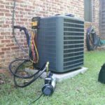 a-large-grey-rectangular-air-conditioning-unit-is-the-central-focus