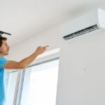 a-man-is-standing-and-decreasing-AC-temperature