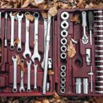 comprehensive-set-of-mechanics-tools-housed-within-a-red-plastic-carrying-case-the-case-is-open-and-resting-on-a-surface