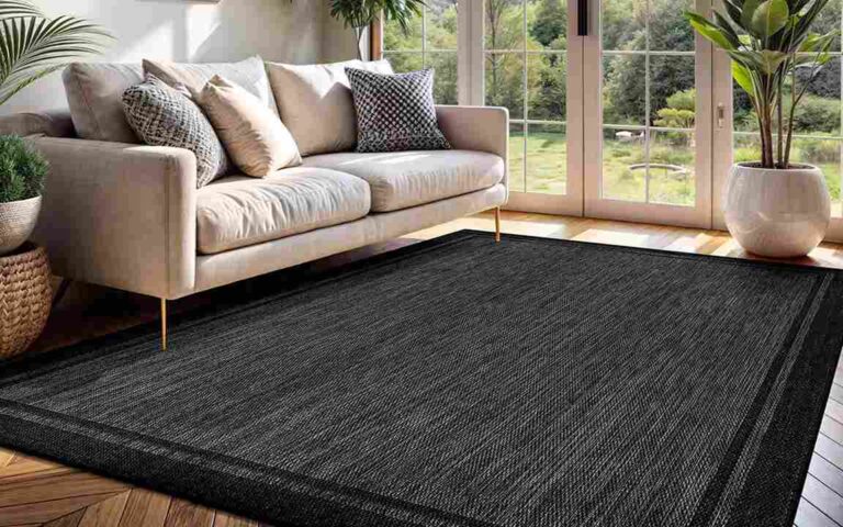 cozy-living-room-features-a-modern-light-gray-sofa-with-various-pillows-and-large-rectangular-area-rug-covers-the-floor