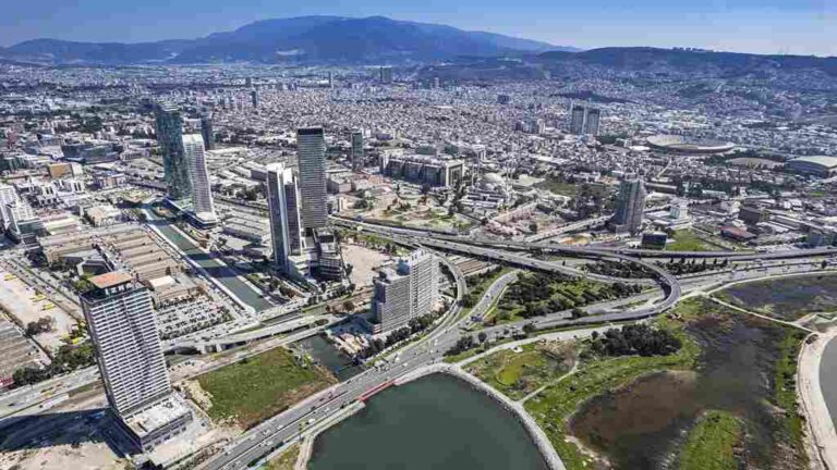 high-rise-building-a-river-body-of-water-winding-through-the-urban-area-and-complex-road-system-and-bridges
