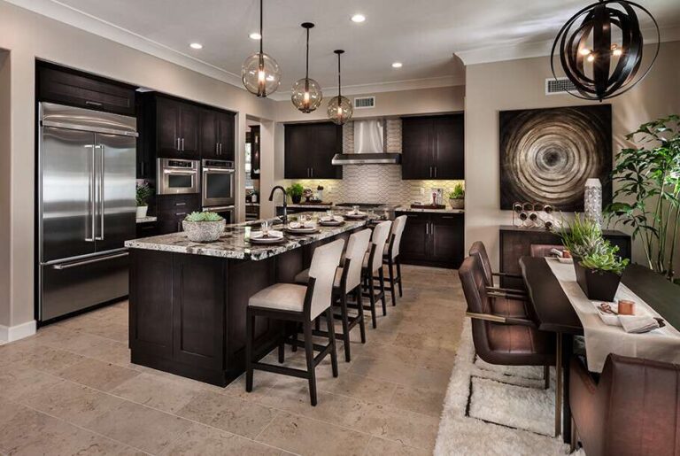 kitchen-features-dark-wood-cabinetry-and-light-colored-marble-countertops-and-large-island-in-the-center