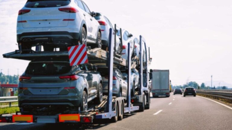 multi-level-truck-is-transporting-several-new-cars-which-appear-to-be-SUVs