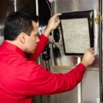 technician-replacing-air-filter-inside-an-HVAC-system