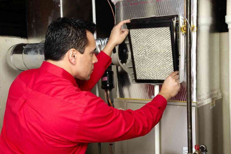technician-replacing-air-filter-inside-an-HVAC-system