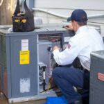 technician-working-on-outdoor-HVAC-condenser-unit