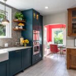 the-cabinet-are-in-a-deep-blue-color-featuring-a-shaker-style-door-and-tall-cabinet-unit-housing-an-oven-and-microwave