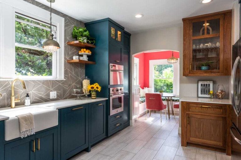Three Final Touches to Enhance Your Kitchen’s Aesthetic the-cabinet-are-in-a-deep-blue-color-featuring-a-shaker-style-door-and-tall-cabinet-unit-housing-an-oven-and-microwave