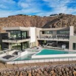 the-home-features-a-contemporary-design-extensive-floor-to-ceiling-glass-windows-and-intergrates-home-into-the-hillside-terrain