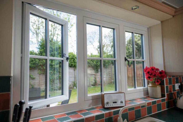 three-large-white-windows-allowing-natural-light-into-the-kitchen