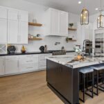 white-color-kitchen-with-white-cabinets-and-white-and-black-table-on-center