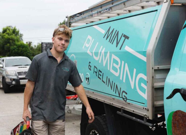 Experienced Plumber in Randwick and Plumber in Rose Bay for Residential & Commercial Needs a-plumber-wearing-a-dark-blue-work-shirt-and-light-colored-shorts-is-standing-beside-a-service-truck
