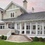 big-beautiful-white-two-story-house-with-a-porch-wooden-steps-and-green-lawn-in-front